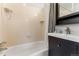 Cozy bathroom with tiled shower, sink, and vanity at 2515 Ames St, Edgewater, CO 80214