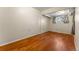 Bedroom featuring hardwood floors, neutral walls, and a bright window at 2515 Ames St, Edgewater, CO 80214