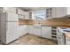 Well-lit kitchen equipped with white appliances and ample cabinet space at 2515 Ames St, Edgewater, CO 80214