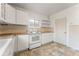 Efficient kitchen featuring white cabinets, tiled floors and wood countertops at 2515 Ames St, Edgewater, CO 80214