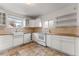Bright kitchen with white cabinets, farmhouse sink, and wood countertops at 2515 Ames St, Edgewater, CO 80214
