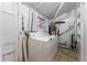 Laundry room featuring a washer, dryer, water heater, and white colored walls at 2515 Ames St, Edgewater, CO 80214