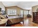 Bedroom with vaulted ceilings, hardwood floors, plantation shutters, and elegant furniture at 1853 S Marshall Cir, Lakewood, CO 80232