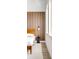 Cozy bedroom showcasing wood slat headboard, ambient lighting, and natural light from nearby windows at 9185 W Eaton St, Westminster, CO 80031
