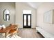 Bright entryway with double glass doors, modern decor, and light wood floors create a welcoming space at 9185 W Eaton St, Westminster, CO 80031