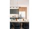 Modern kitchen with an island, sleek cabinets, stainless steel refrigerator, and stylish bar stools at 9185 W Eaton St, Westminster, CO 80031