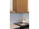 Modern kitchen with wood accents, stainless steel range, granite counters and white kettle at 9185 W Eaton St, Westminster, CO 80031