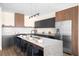 Modern kitchen with a large island, granite countertops, stainless steel appliances, and seating at 9185 W Eaton St, Westminster, CO 80031