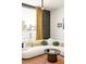 Bright living room featuring a plush white sofa, stylish coffee table, and colorful patterned wallpaper at 9185 W Eaton St, Westminster, CO 80031