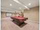 Finished basement with a pool table, projector screen, and carpet at 11704 Hale Ct, Parker, CO 80138