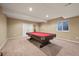 Finished basement featuring a pool table, carpet, and window at 11704 Hale Ct, Parker, CO 80138