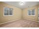 Basement bedroom has neutral carpet and two windows allowing for ample light at 11704 Hale Ct, Parker, CO 80138