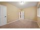 Cozy bedroom featuring neutral walls and carpeting with two doors to closets and hallways at 11704 Hale Ct, Parker, CO 80138