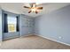 Comfortable bedroom has neutral carpet, a ceiling fan, and convenient built-in shelving at 11704 Hale Ct, Parker, CO 80138