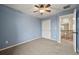 A bright bedroom features a ceiling fan, closet, and neutral carpet at 11704 Hale Ct, Parker, CO 80138