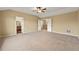 Large bedroom with neutral carpet; bathroom and hallway entrances visible at 11704 Hale Ct, Parker, CO 80138