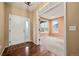 Bright foyer with hardwood floors, white front door, and entrance to a carpeted room at 11704 Hale Ct, Parker, CO 80138