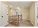 Well-lit hallway features carpet, a wooden banister, and views into other rooms at 11704 Hale Ct, Parker, CO 80138