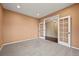 Bright and airy office space with cozy carpeting and glass French doors to hallway at 11704 Hale Ct, Parker, CO 80138