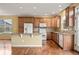 Bright kitchen featuring an island, granite countertops, wood cabinets and hardwood floors at 11704 Hale Ct, Parker, CO 80138