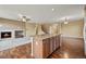 Spacious kitchen island connecting to the living room with a fireplace and hardwood floors at 11704 Hale Ct, Parker, CO 80138