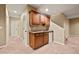Basement kitchenette features granite counters, wood cabinets and a convenient under-counter fridge at 11704 Hale Ct, Parker, CO 80138