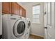 Convenient laundry room with modern washer and dryer, storage cabinets, and tile flooring at 11704 Hale Ct, Parker, CO 80138