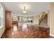 Open-concept living room featuring a cozy fireplace, staircase, and hardwood floors throughout at 11704 Hale Ct, Parker, CO 80138
