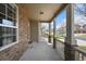 Inviting covered front porch with brick accents and view of the neighborhood street at 11704 Hale Ct, Parker, CO 80138