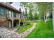 Back of the home with a rock feature and a grassy lawn at 34 Highfield Trl # 112, Breckenridge, CO 80424