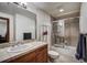 Bathroom featuring a shower-over-tub with glass enclosure, and vanity with tiled countertop at 34 Highfield Trl # 112, Breckenridge, CO 80424