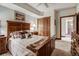 Cozy bedroom with a wood bed, decorative pillows and closet space at 34 Highfield Trl # 112, Breckenridge, CO 80424
