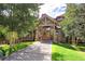 Exterior view of the condo building's entrance with stone and wood accents at 34 Highfield Trl # 112, Breckenridge, CO 80424
