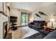 Comfortable living room with fireplace and sliding glass door to the backyard at 34 Highfield Trl # 112, Breckenridge, CO 80424
