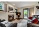 Relaxing living room with a stone fireplace and a sliding glass door to the backyard at 34 Highfield Trl # 112, Breckenridge, CO 80424