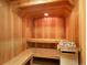 Relaxing home sauna with wooden benches, wall panels and heater with lava rocks at 34 Highfield Trl # 112, Breckenridge, CO 80424