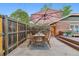 Cozy backyard patio with outdoor dining set, umbrella, and access to the deck area at 4003 Federal Blvd, Denver, CO 80211