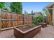 Backyard garden area featuring raised garden beds and a gravel ground cover at 4003 Federal Blvd, Denver, CO 80211