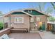Back exterior of home featuring a small deck, patio, and access to street at 4003 Federal Blvd, Denver, CO 80211