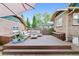 Inviting backyard deck featuring ample seating, planters, and shade under a large umbrella at 4003 Federal Blvd, Denver, CO 80211