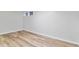 Clean basement area featuring wood-look flooring and bright lighting at 4003 Federal Blvd, Denver, CO 80211