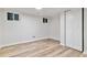 Finished basement space with wood-look flooring, lighting, and storage options at 4003 Federal Blvd, Denver, CO 80211