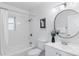 Bright bathroom featuring a shower over tub with white subway tile and a modern vanity at 4003 Federal Blvd, Denver, CO 80211