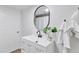 Bathroom featuring modern vanity with black faucet, framed mirror and storage at 4003 Federal Blvd, Denver, CO 80211