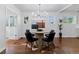 Elegant dining room featuring a round table, modern chandelier, and stylish decor at 4003 Federal Blvd, Denver, CO 80211