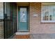 Attractive front entrance with a stylish door, brick facade, and vintage mail box at 4003 Federal Blvd, Denver, CO 80211