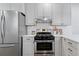 Modern kitchen showcasing stainless steel appliances, white cabinets, and clean countertops at 4003 Federal Blvd, Denver, CO 80211