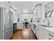 Bright kitchen featuring stainless steel appliances, white cabinets and hardwood floors at 4003 Federal Blvd, Denver, CO 80211