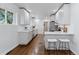 Bright kitchen featuring white cabinets, stainless steel appliances, and hardwood floors at 4003 Federal Blvd, Denver, CO 80211