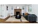 Bright living room featuring a brick fireplace, modern sofa, and stylish decor at 4003 Federal Blvd, Denver, CO 80211